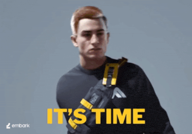 a man wearing a black sweater and a yellow bag with the words it 's time written on it