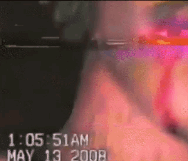 a blurred image of a person 's face with the date may 13 2008