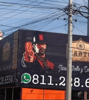 a large billboard with a cowboy holding a gun and the number 8112.8.6 on it