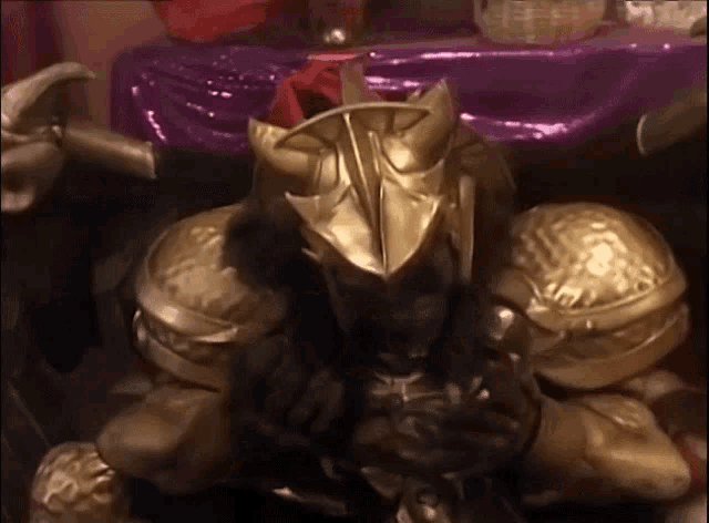 a statue of a knight with a gold helmet and armor