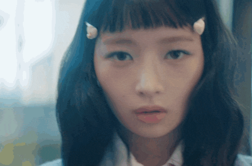 a close up of a girl 's face with a white shirt