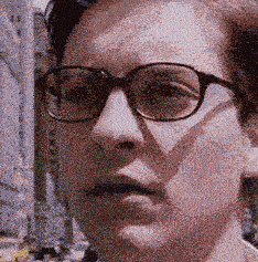 a close up of a person 's face with glasses