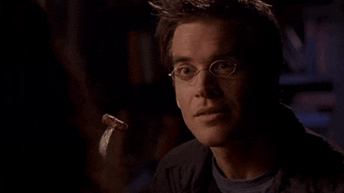 a man with glasses and a sausage on a fork