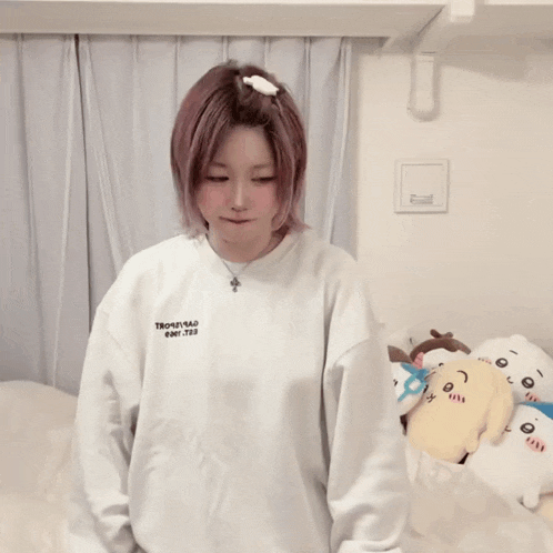 a girl wearing a white sweatshirt that says ' thousand ' on it