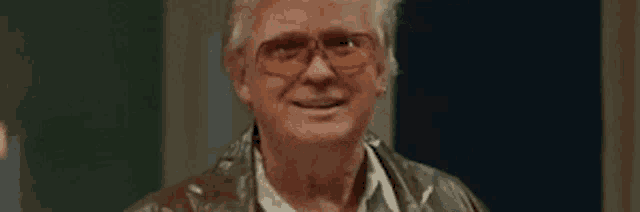 a man wearing glasses is smiling with the word winning above him