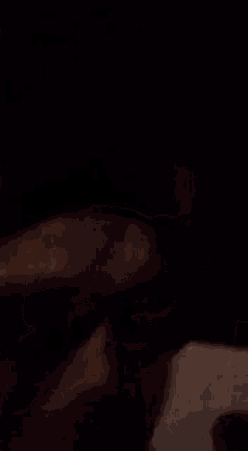 a close up of a person wearing sunglasses in a dark room .