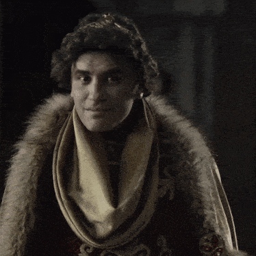 a man with a crown on his head is wearing a fur coat and a scarf around his neck