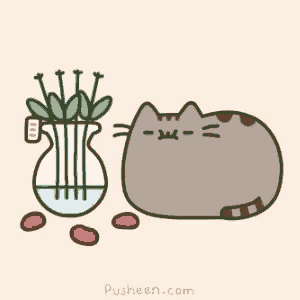a pusheen cat is laying next to a vase of flowers .