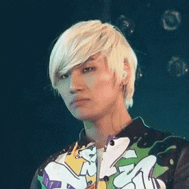 a young man with blonde hair is wearing a colorful jacket with a mtv logo on it
