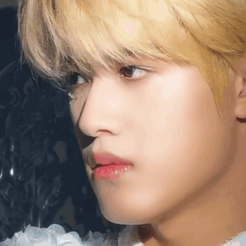 a close up of a man 's face with blonde hair and red lips