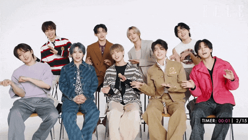 a group of young men are posing for a photo with a timer that says 00 01 2 15