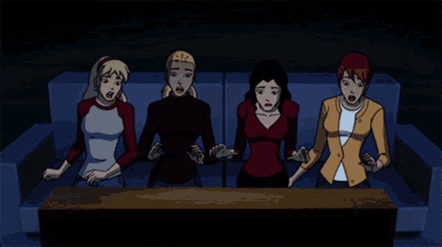 a group of women sitting on a couch with their hands on their head