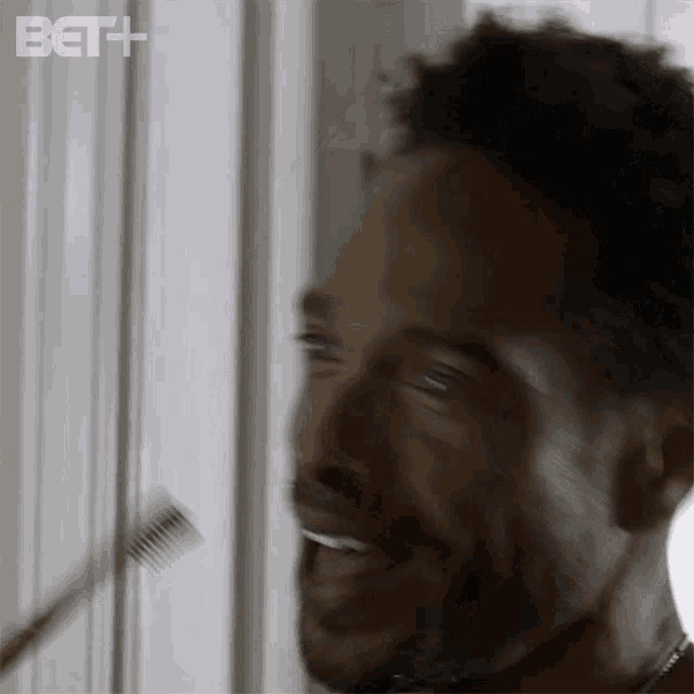 a man is brushing his teeth in front of a mirror with beth written on the bottom right