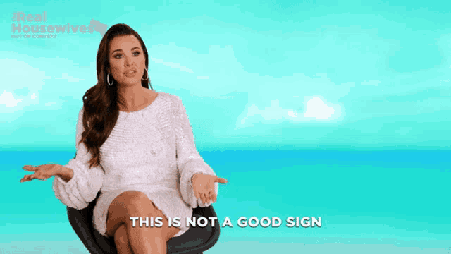 a woman sitting in a chair with the words this is not a good sign