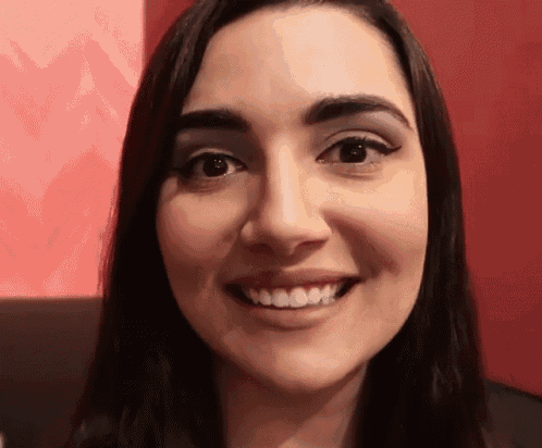 a close up of a woman 's face smiling