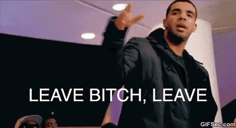 a man in a black jacket is standing in front of a crowd and says leave bitch leave