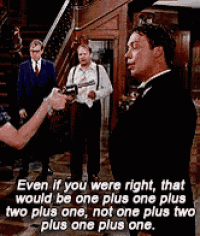 a man in a tuxedo is holding a gun in front of a group of men in suits