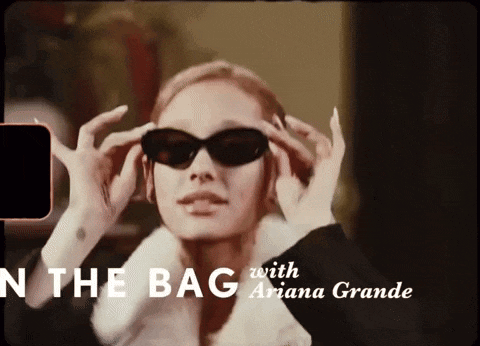 a woman wearing sunglasses and a fur coat is in a video with ariana grande .