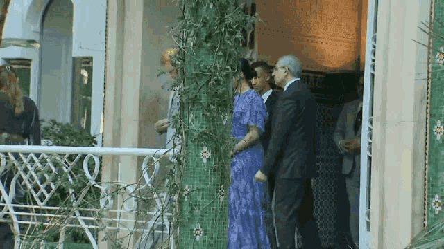 a group of people standing outside of a building