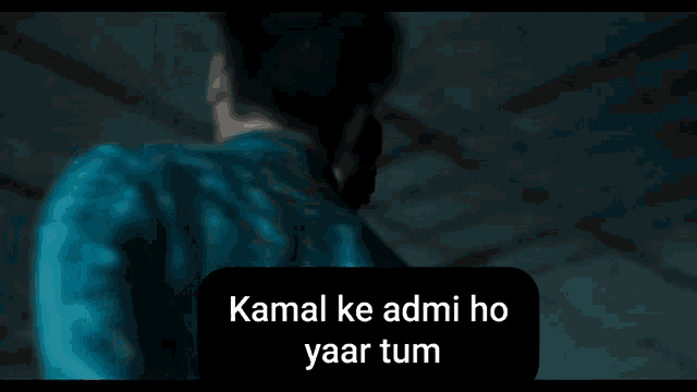 a man in a blue shirt is talking to another man with the words kamal ke admi ho yaar tum above him