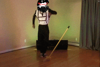 a man in a pirate costume is dancing with a mop
