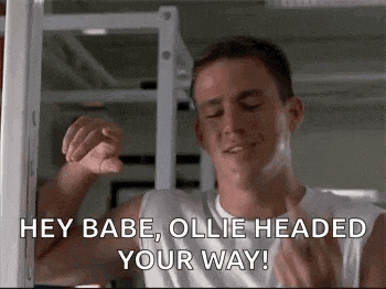 a man is flexing his muscles and saying `` hey babe , ollie headed your way '' .