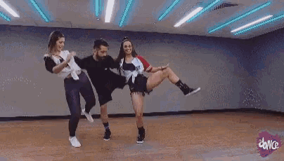 a man and a woman are dancing in a dance studio .