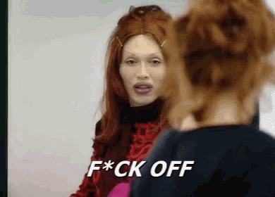 a woman in a red wig says f * ck off