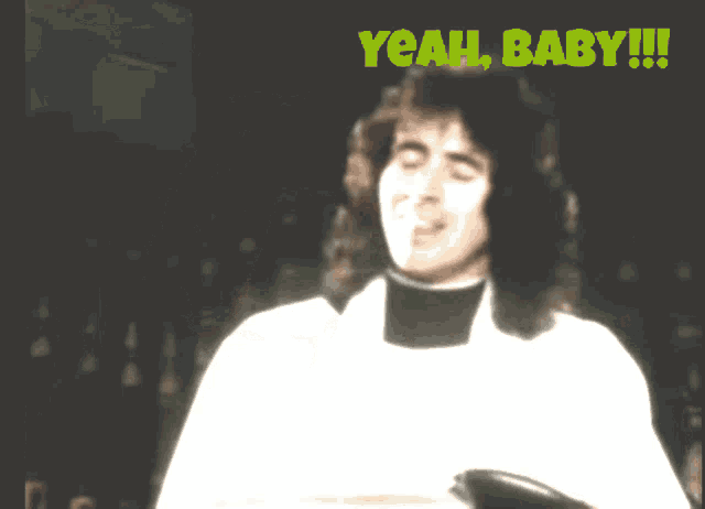 a man in a white shirt says yeah baby !!!