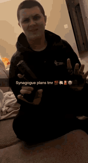a man holding a gun with the caption synagogue plans tmr above him