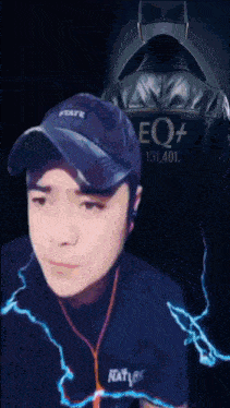 a man wearing a hat and a jacket that says eq +