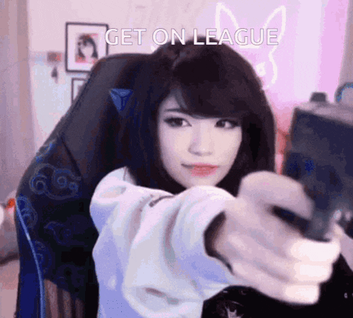 a girl is sitting in a chair holding a gun and the words " get on league " are above her