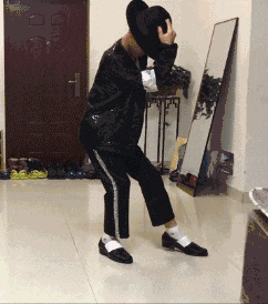 a person is dancing in front of a mirror and a door