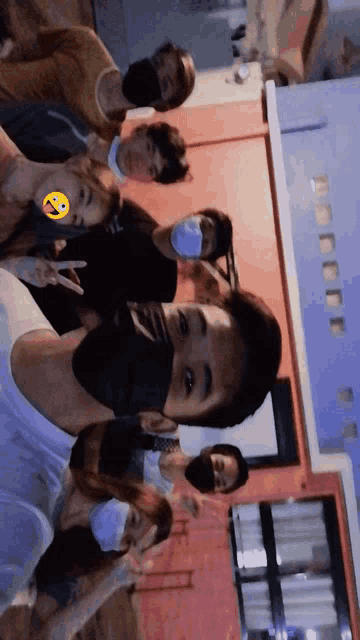 a group of young people wearing face masks pose for a picture