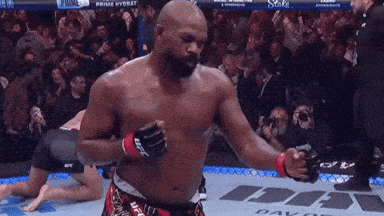 a man in a boxing ring with a ufc logo on the wall