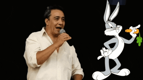 a man singing into a microphone next to bugs bunny