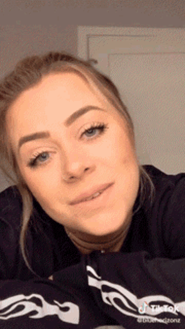 a close up of a woman 's face with a tiktok watermark in the corner