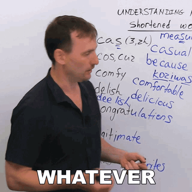 a man is standing in front of a white board with whatever written on the bottom