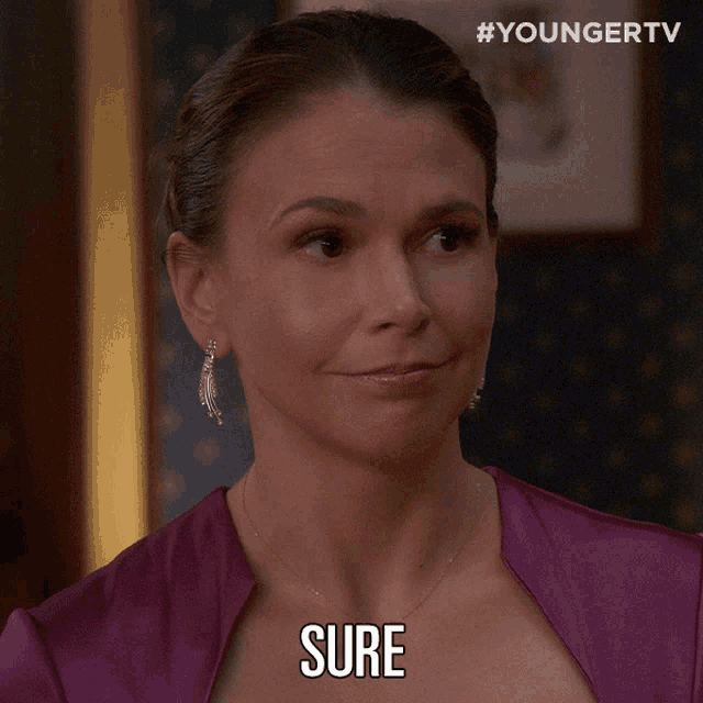 a woman in a purple dress has the word sure on her face