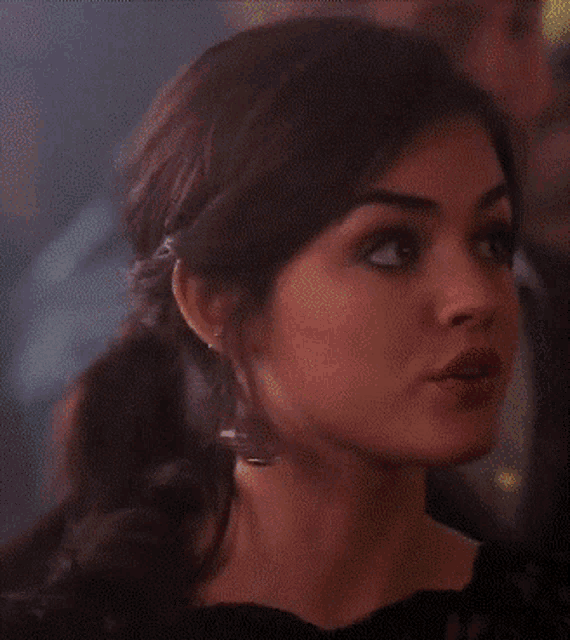 a close up of a woman 's face with earrings