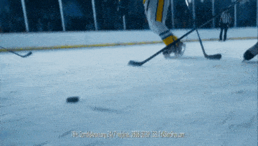 a hockey game is being played on a ice rink and the website is 18+