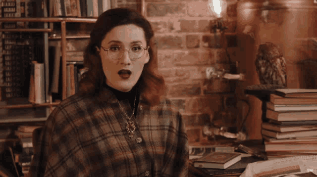 a woman says " hau that 's f * kin ' gay " in front of a pile of books
