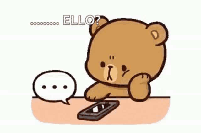 a cartoon teddy bear is sitting at a table with a cell phone .