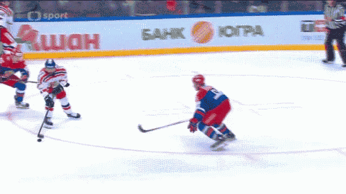 a hockey game is being played in front of a tissot and skoda advertisement