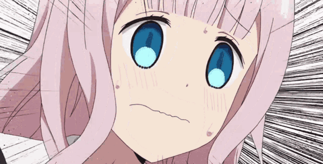 a girl with pink hair and blue eyes is making a face
