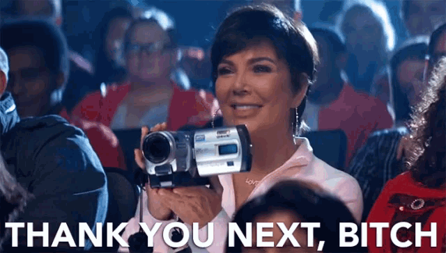 a woman holding a video camera with the words thank you next bitch written below her