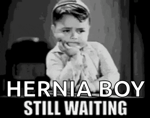 a black and white photo of a little boy with the words `` hernia boy still waiting '' written on it .