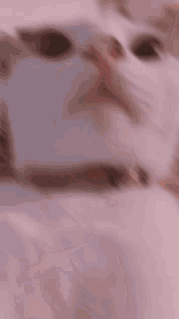 a close up of a person 's face with a blurred background