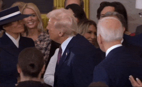 a group of people standing around a man in a suit