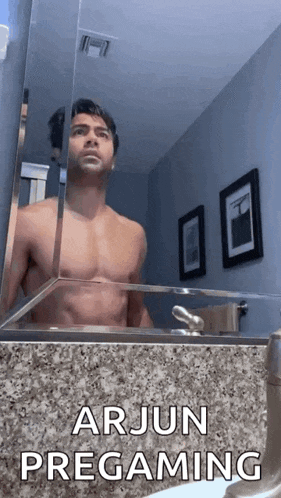 a shirtless man is taking a picture of himself in a bathroom mirror with the caption arjun pregaming